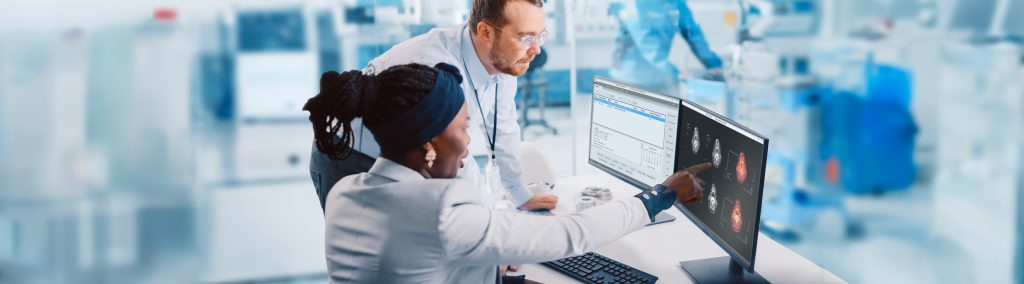 Nuclear medicine staff reviewing imaging and measurement data